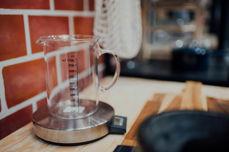 a measuring cup with some measurement tape on it