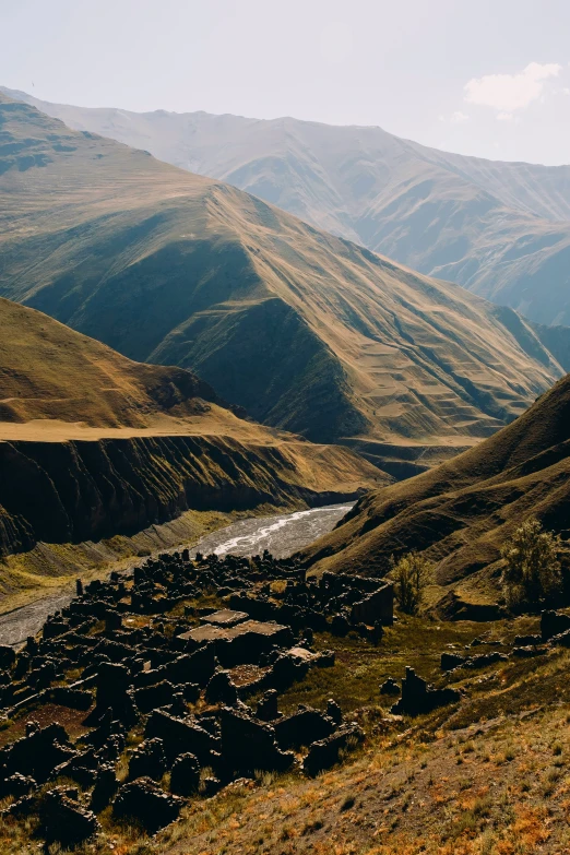 a valley and mountain range from the top of a hill