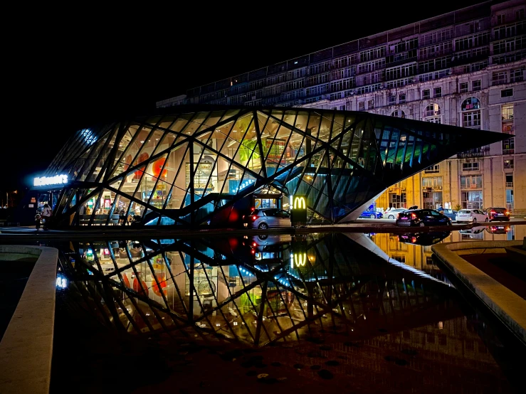 the building is reflecting off of the water