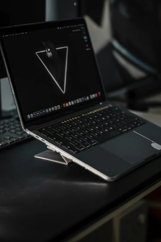 laptops on the desk with an image of a triangle