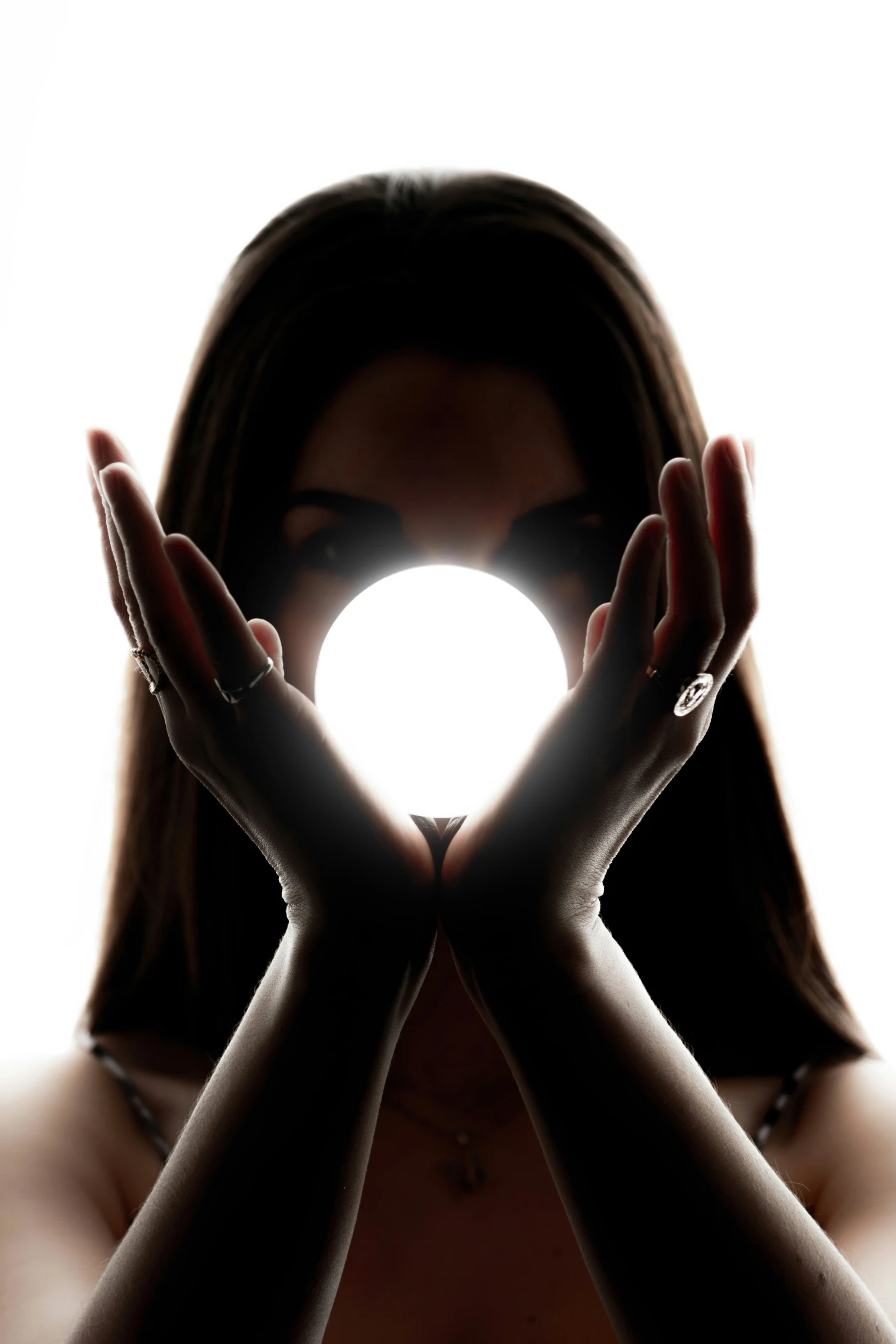 a women in a silhouette with her hands to show the heart shape