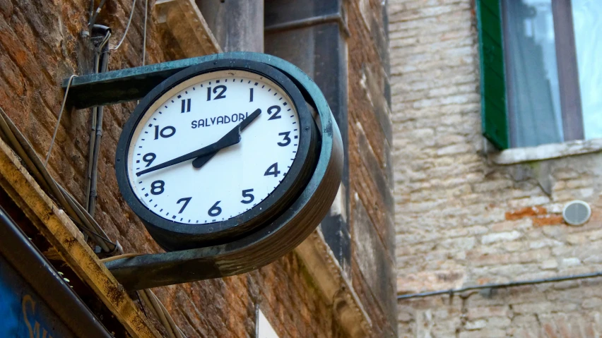 a clock hangs on the side of a building