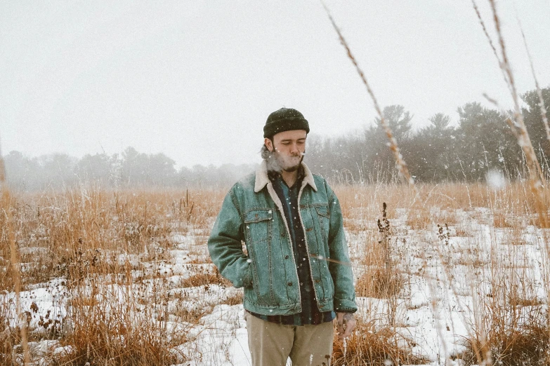 an old man is standing outside in the snow