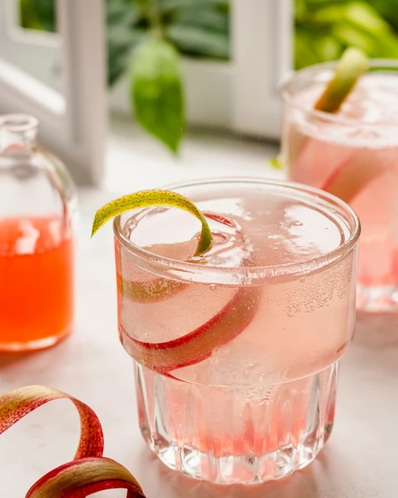 some drinks in glasses and some red liquid