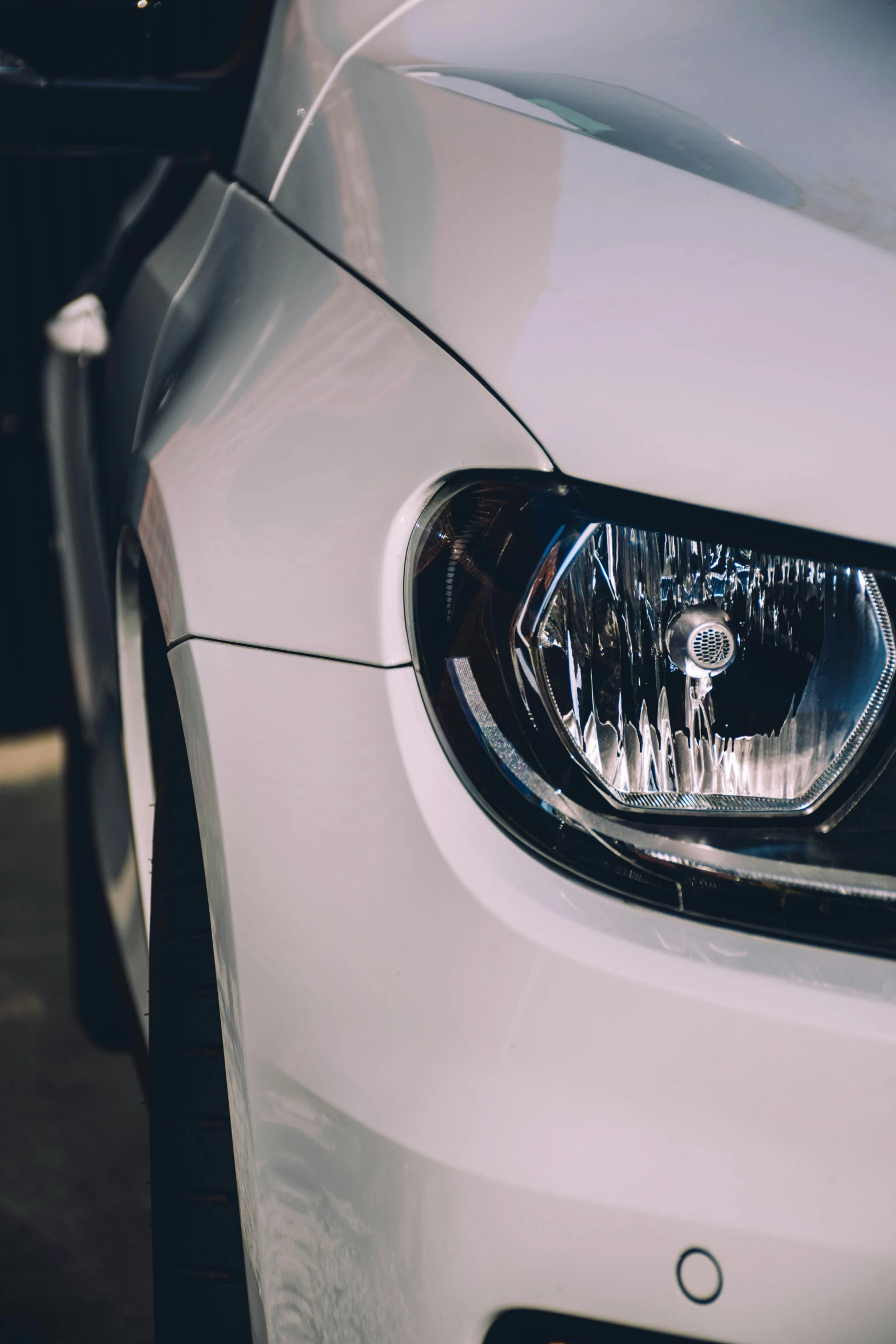 the front end of a car with headlights turned on