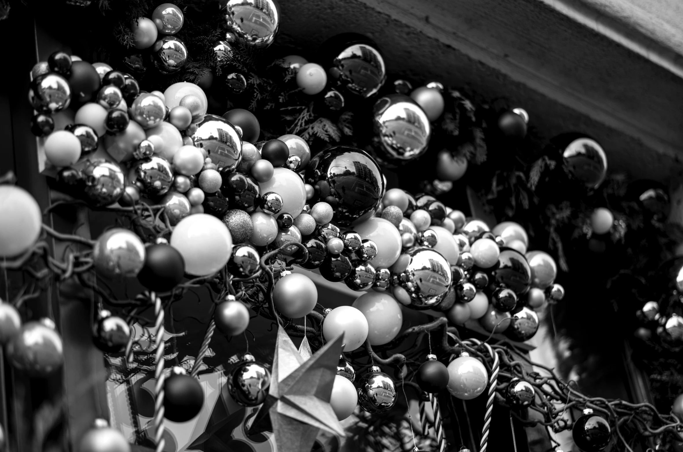 ornaments are hanging on a pole, in black and white