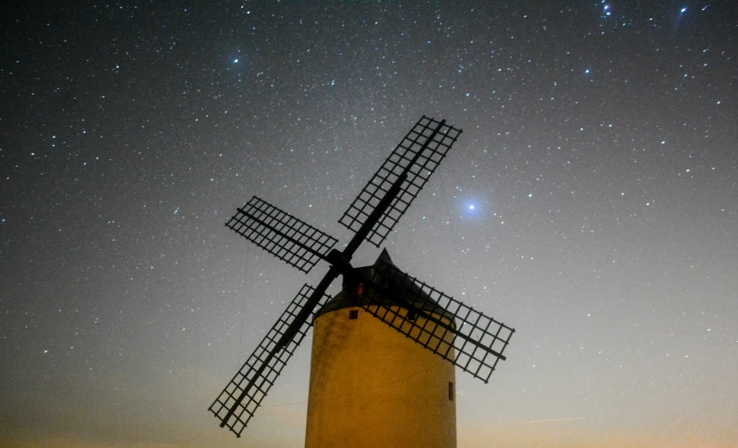 a windmill at night and the stars in the sky