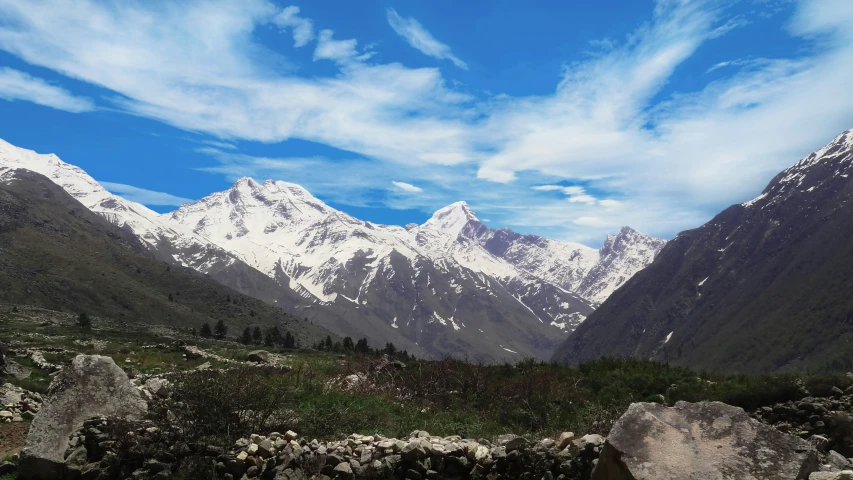 mountains with snow on the tops and rocks below