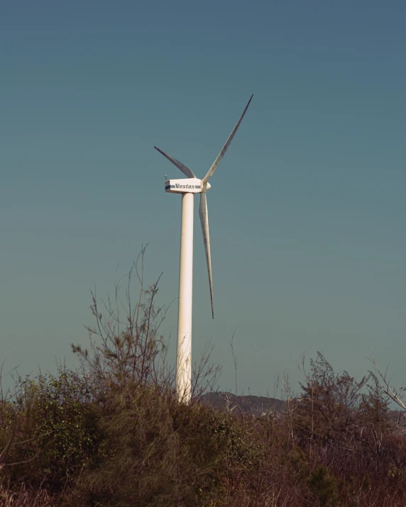 a wind turbine and a building in the background