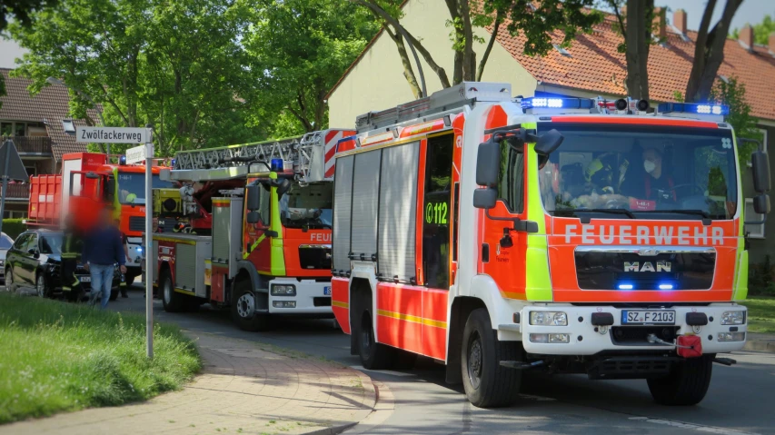 a couple fire trucks are lined up on the side of the road