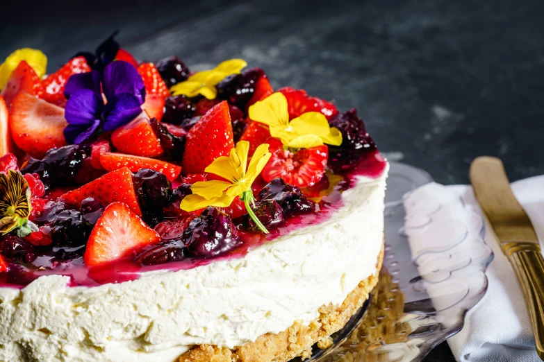 the fruit and flower decorated cake is made from a scratch