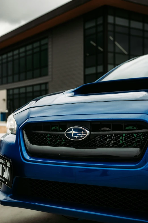 the front view of the blue car parked on the side of the road