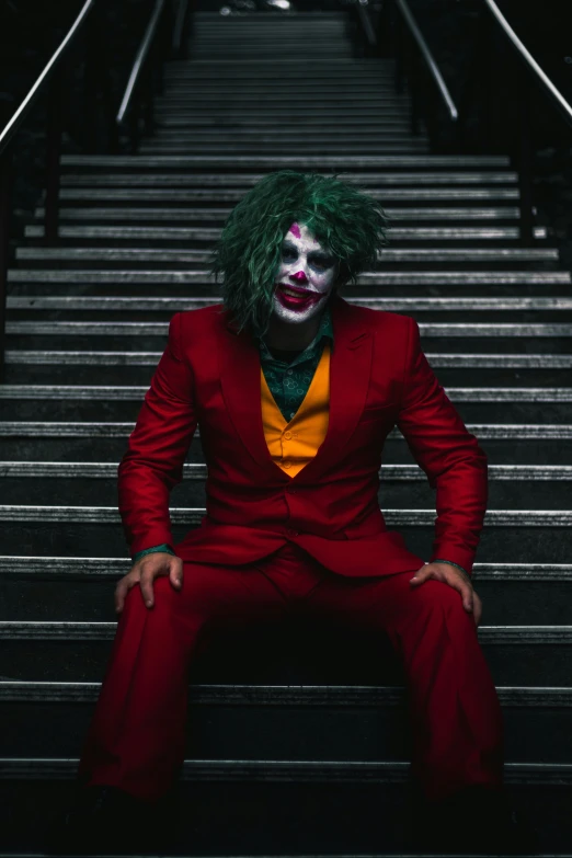 man sitting on a stair case in suit