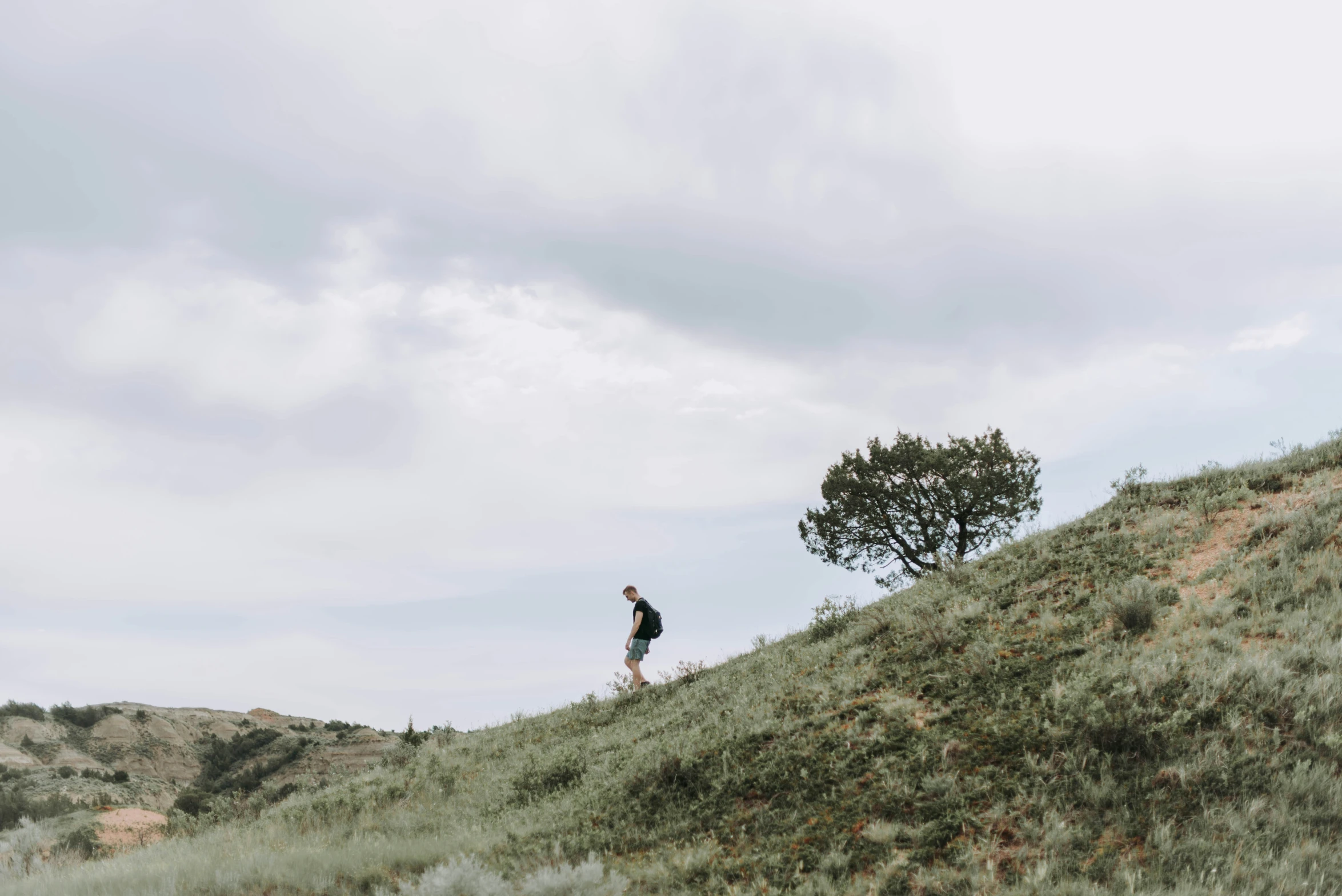 a person that is standing on the side of a hill