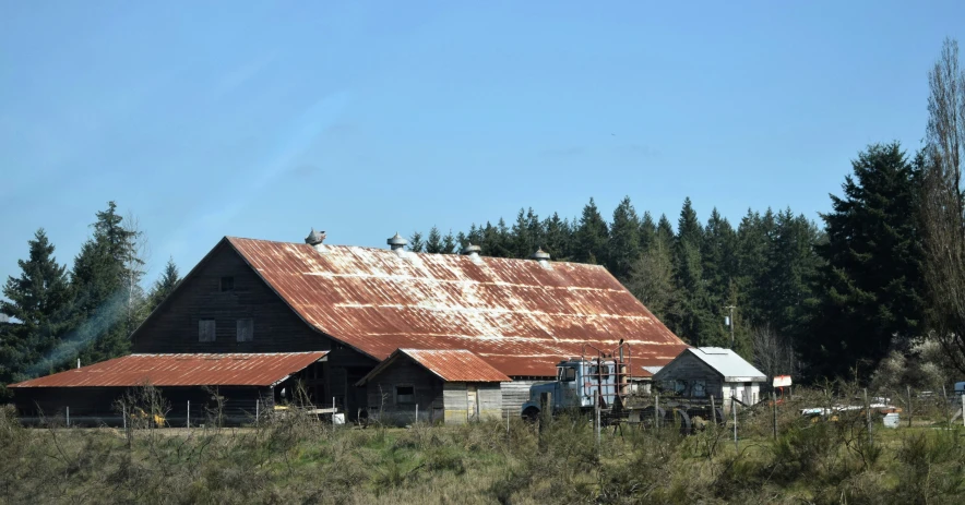 a barn and a few sheep are seen in this image