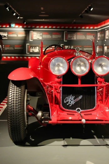 an old red racing car is on display at the museum
