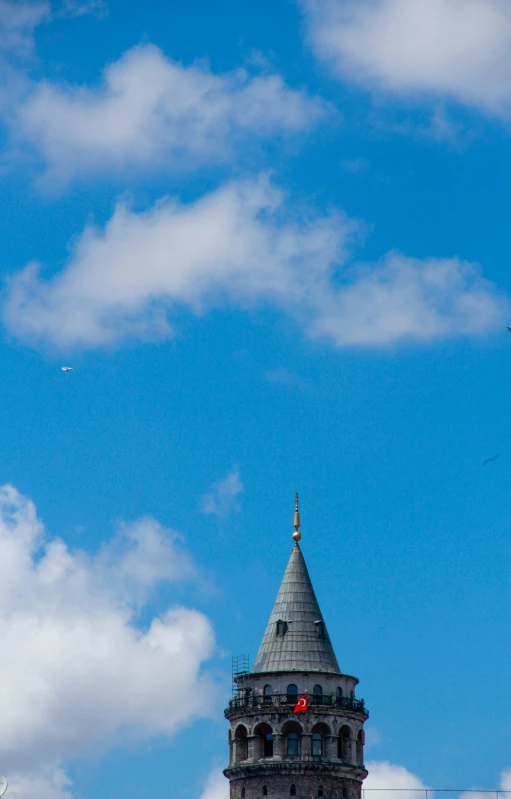 a picture of a clock on a building under the sky