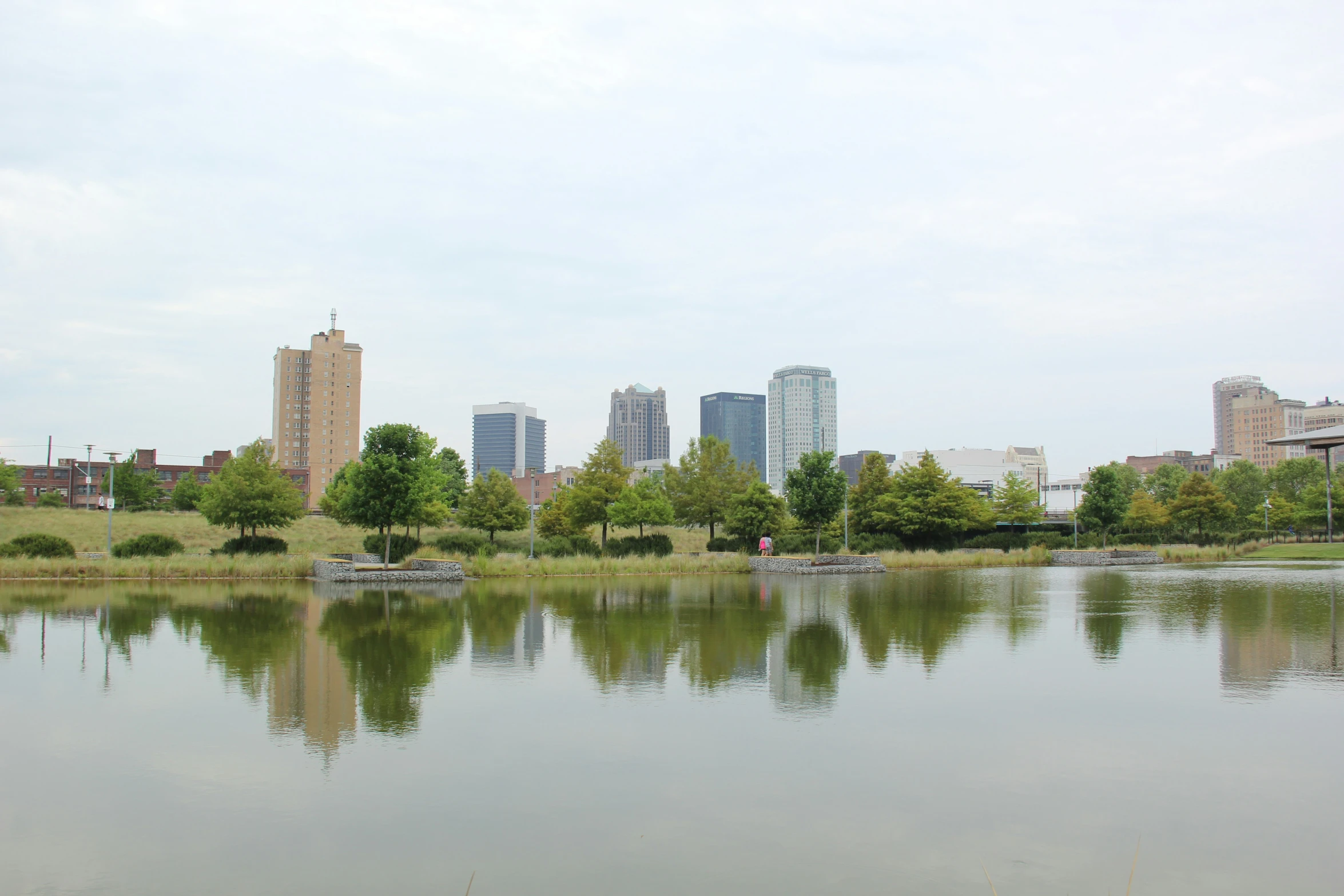 a large body of water sitting in front of tall buildings