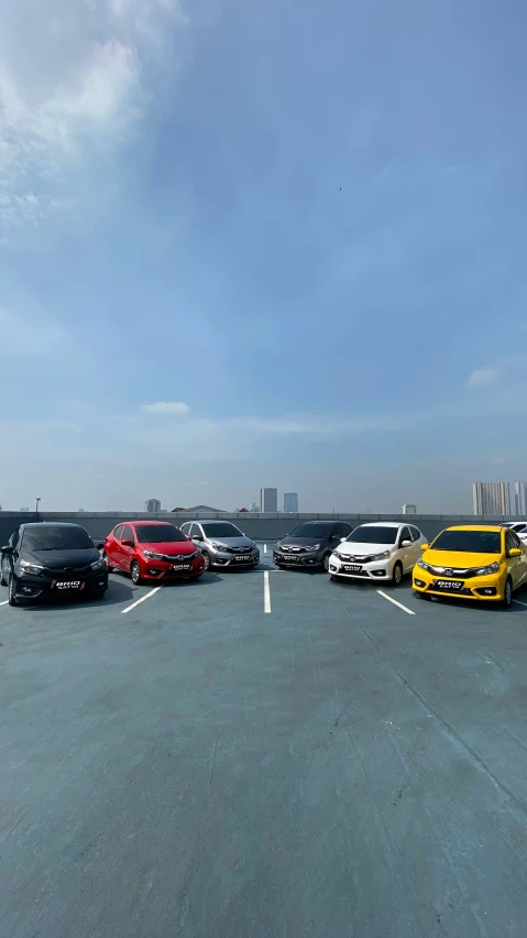 five vehicles parked in a parking lot at an airport