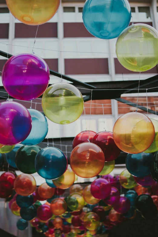 colorful balloons in front of a building with red, yellow and blue