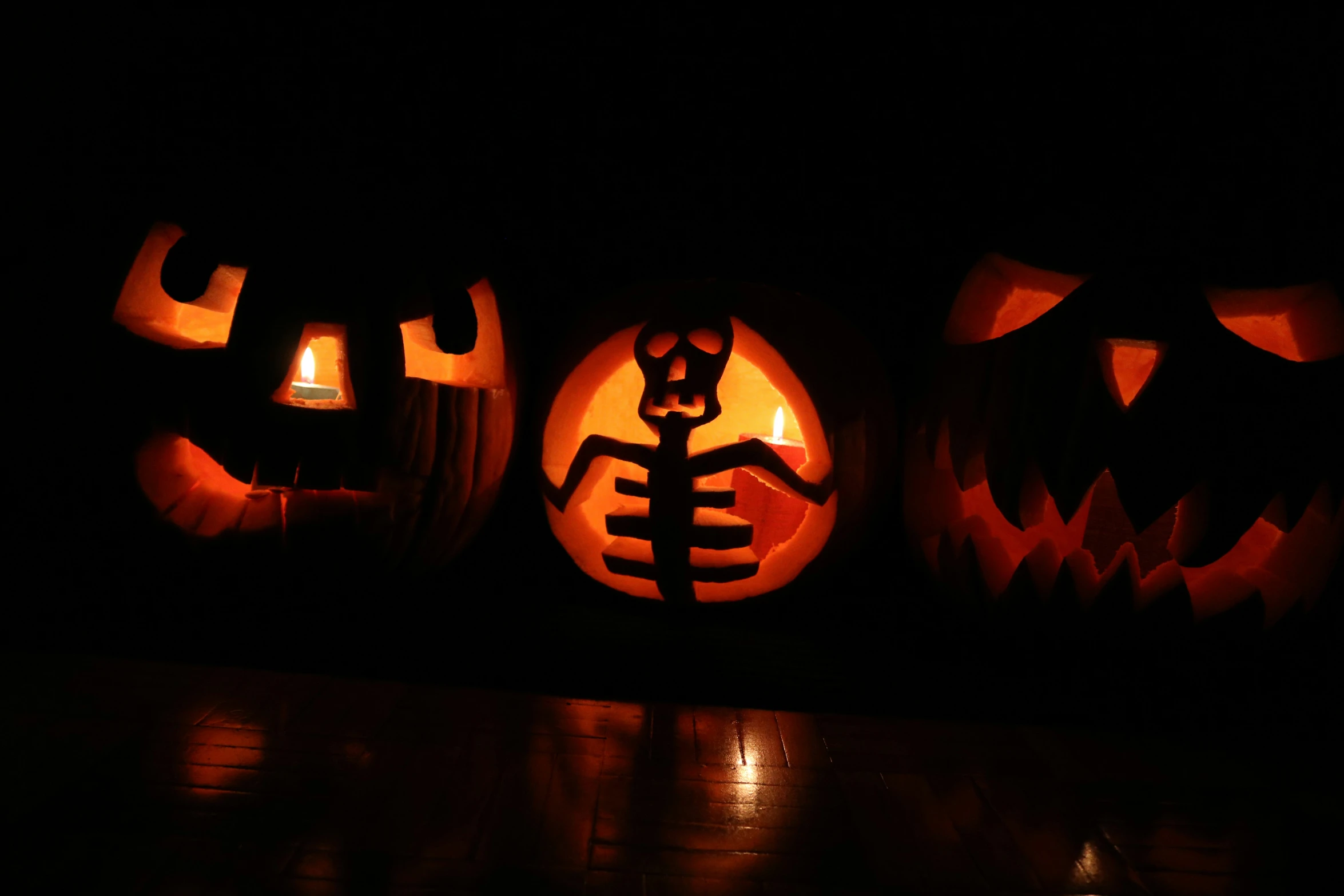 carved pumpkins with scary faces and skeleton faces