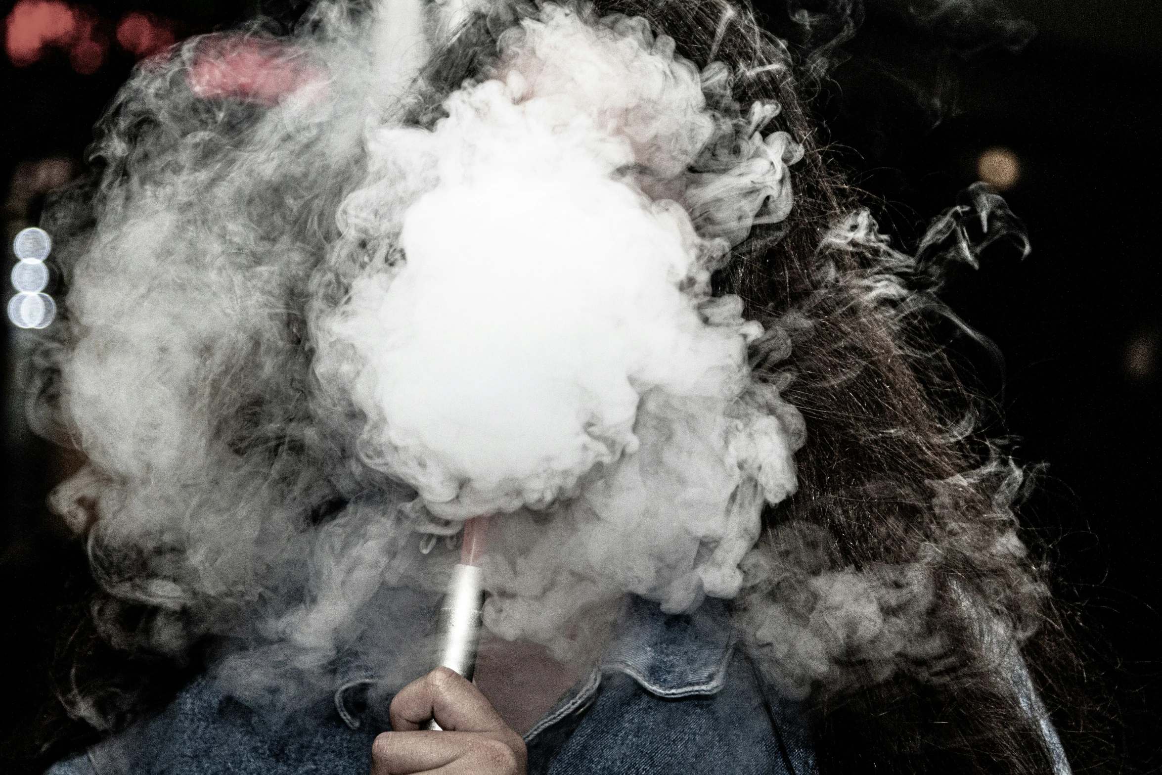 a black and white po of a person holding a smoke bomb