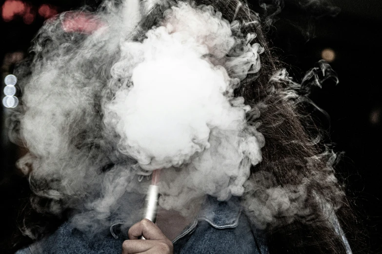 a black and white po of a person holding a smoke bomb