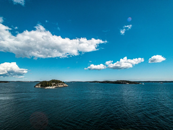 a boat out on the water near two islands