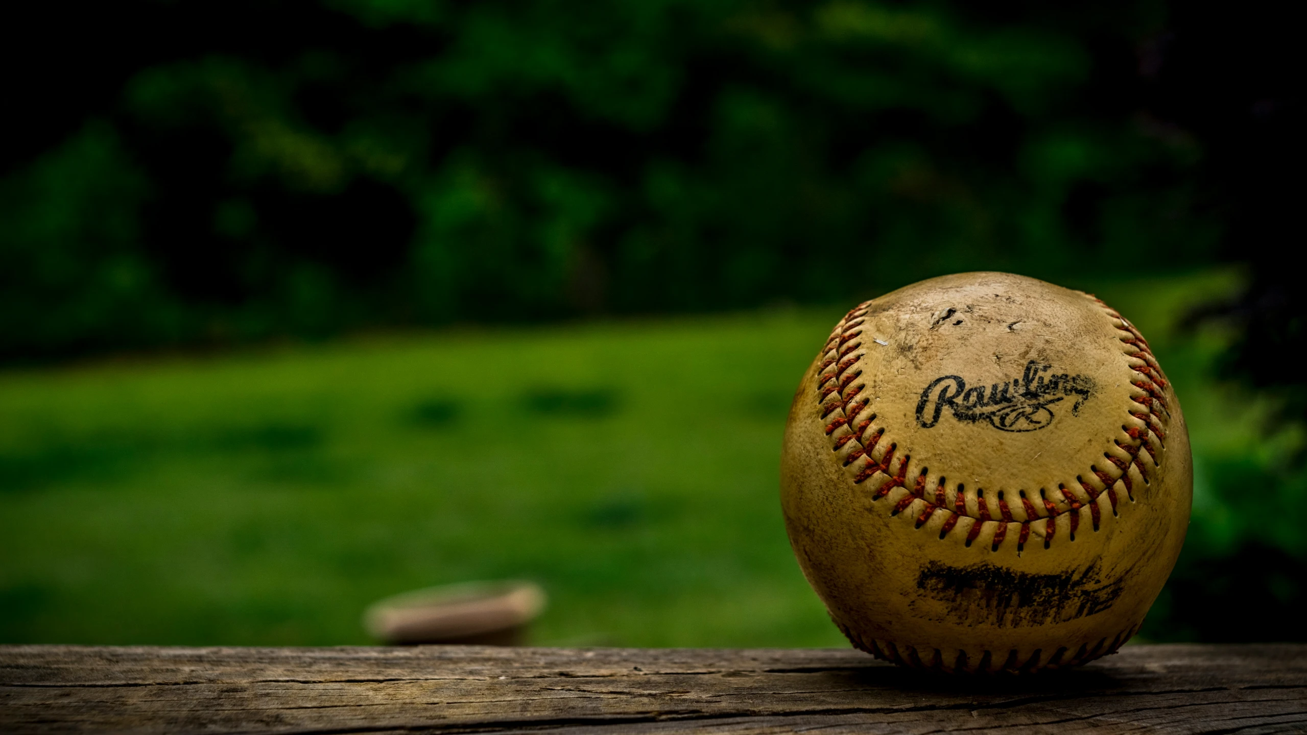 a baseball sitting on top of a wooden table