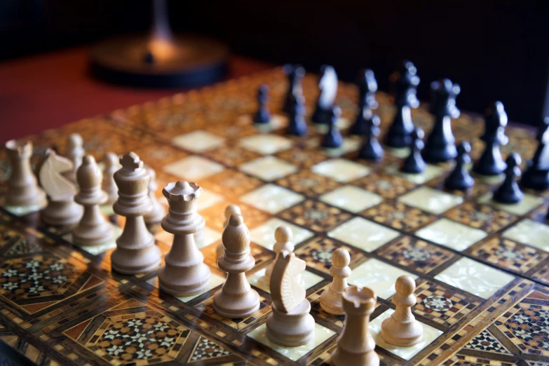 a chess set up with pieces sitting on the table