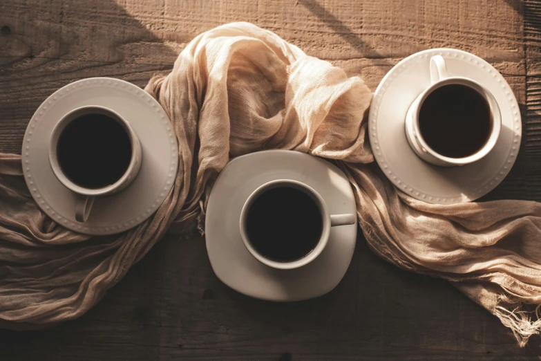 two cups of coffee sitting next to each other