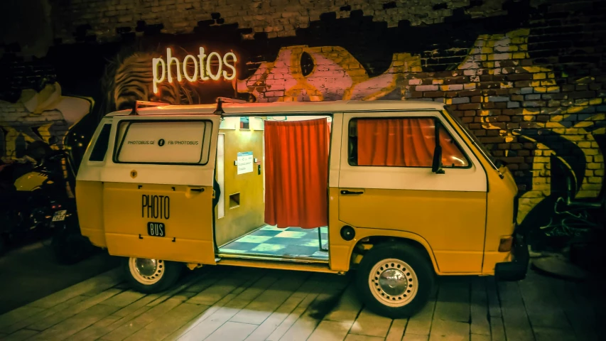 the small yellow van has been placed with red curtains