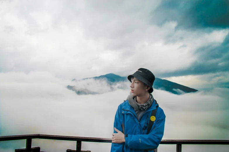 there is a man standing on the edge of a building looking at the sky