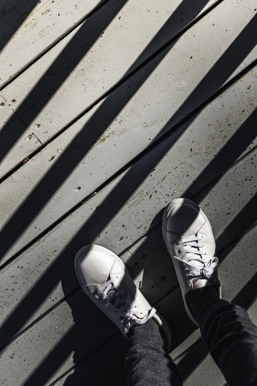 a person standing in the shadows on the ground