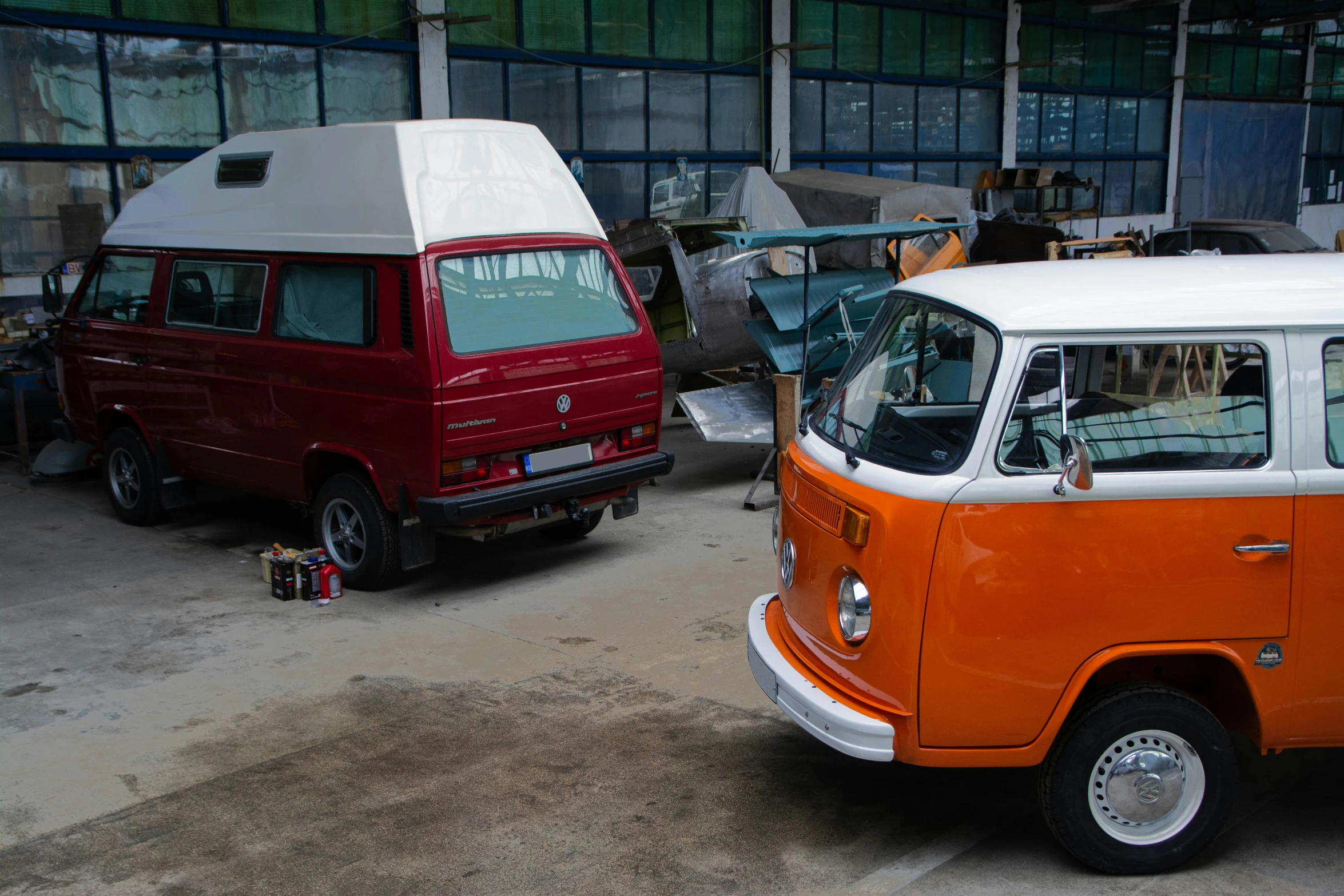 an orange van next to a red van