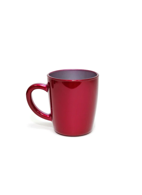 a bright red cup sitting on top of a white table