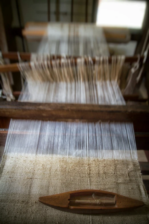 a close up of a piece of fabric near a weaving machine