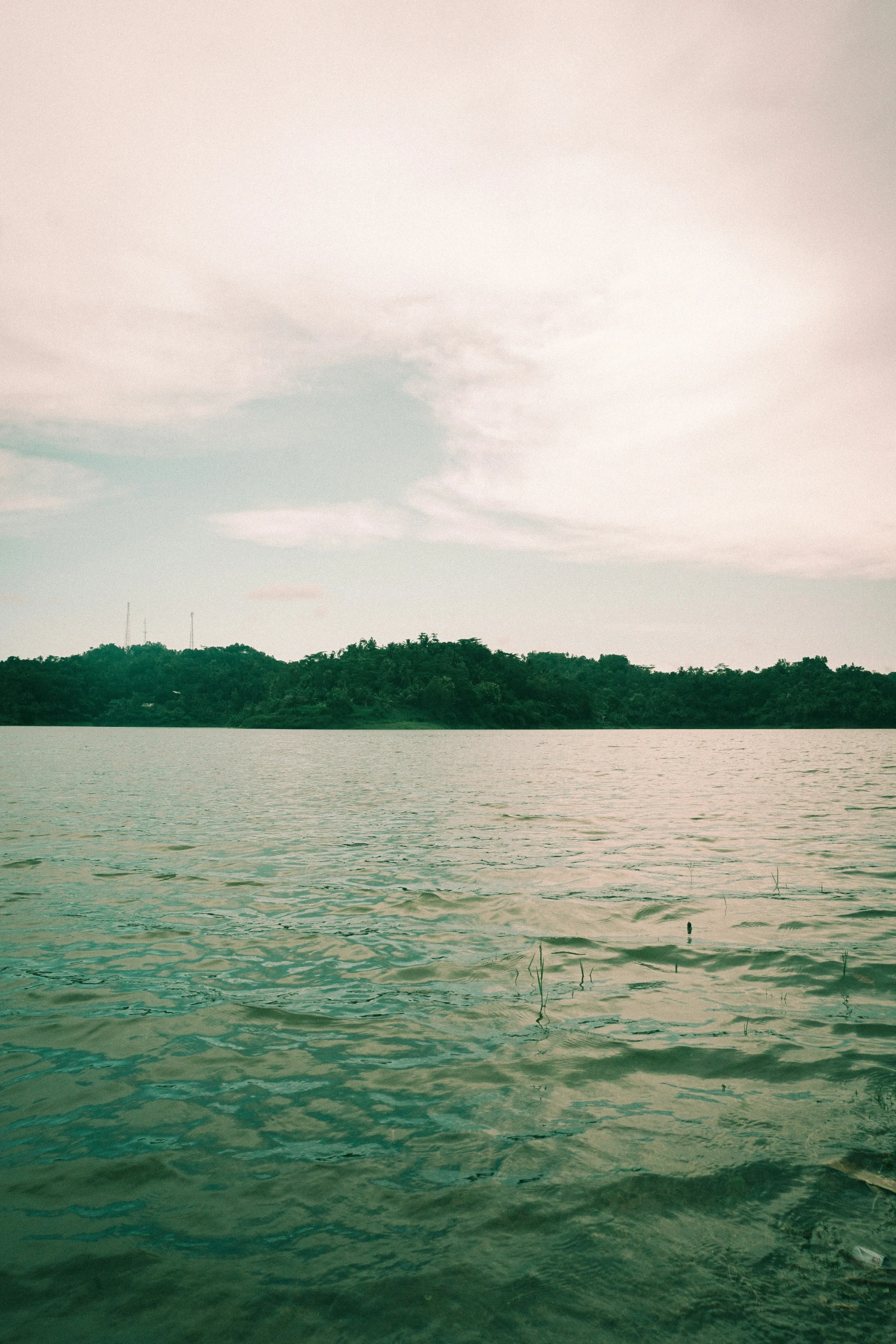 a person para - sailing on the water near some hills