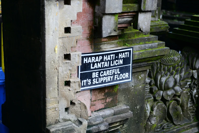 a sign is attached to an old building