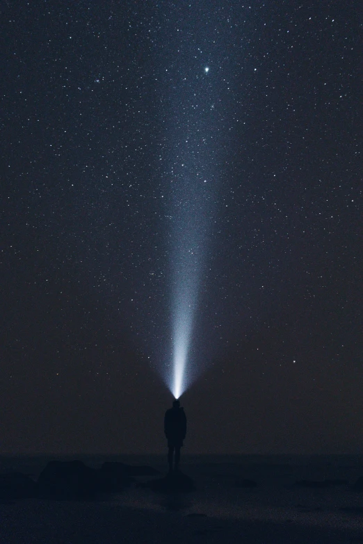 the dark sky has stars and a large comet