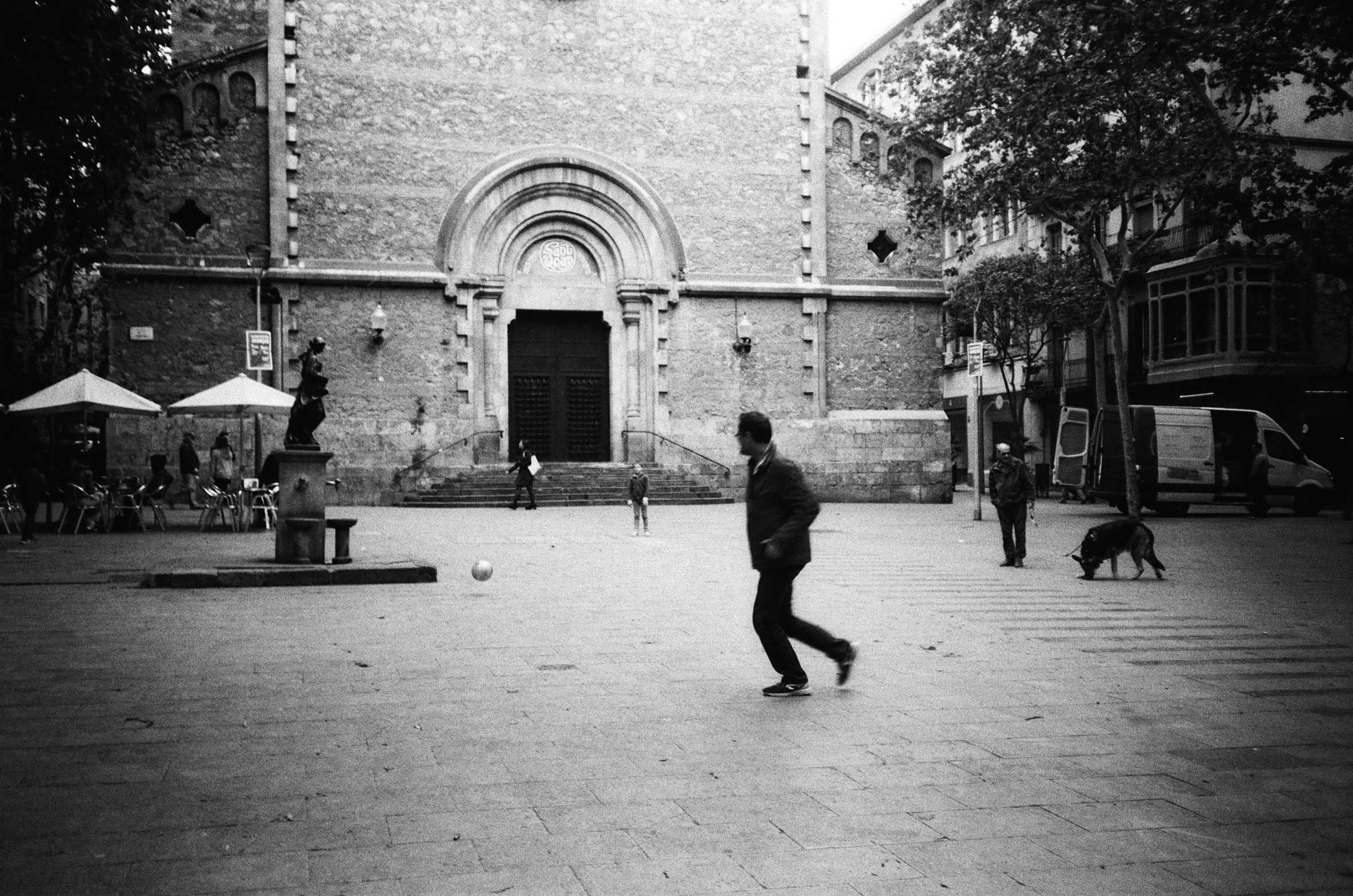 a young man and his dog playing in a park