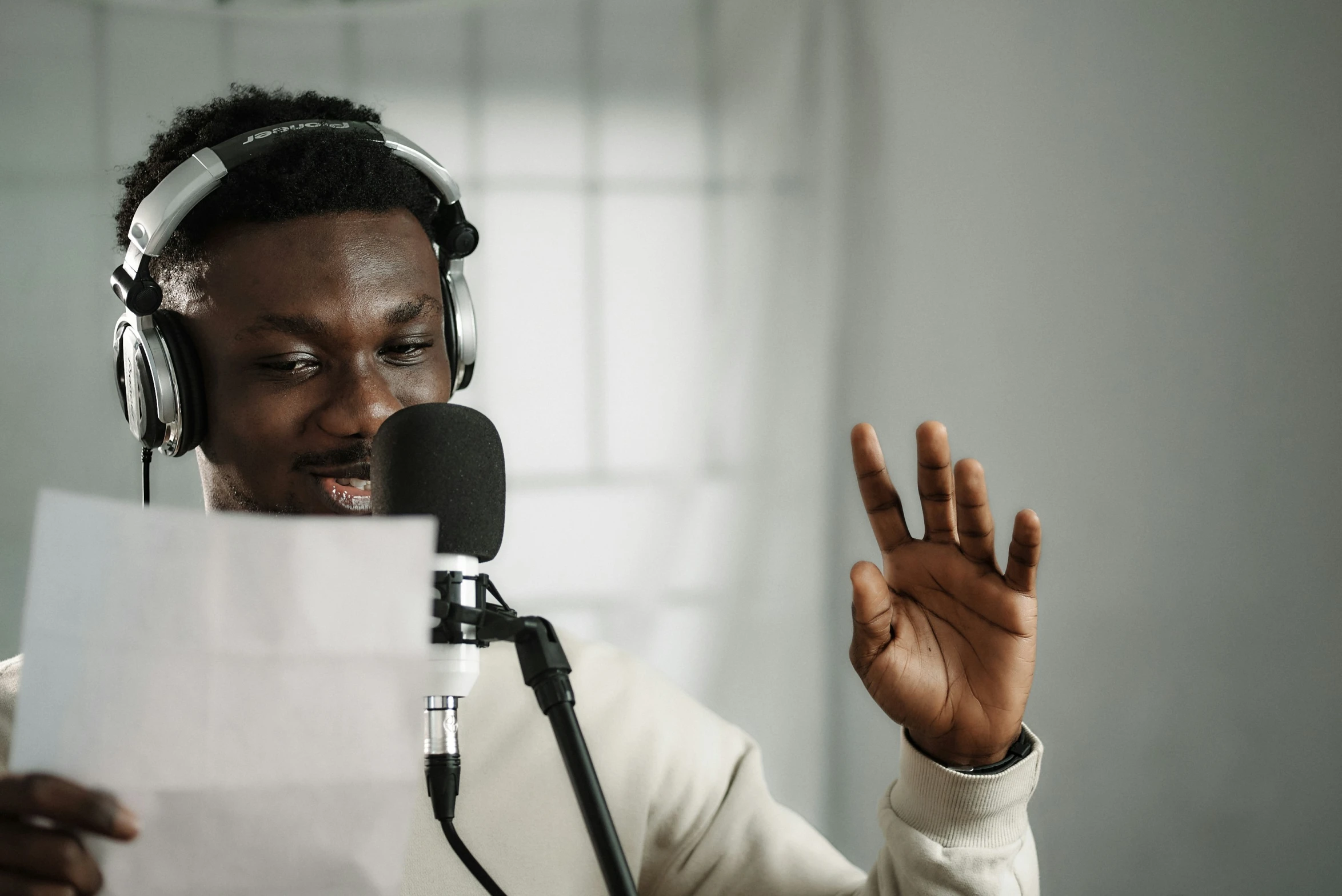 a person sitting down in front of a microphone