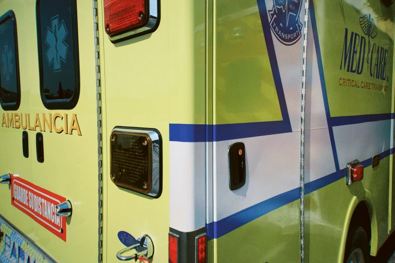 a yellow ambulance has colorful designs on the side