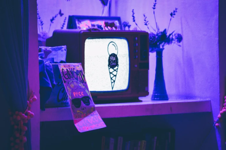 an old television sitting on top of a book shelf