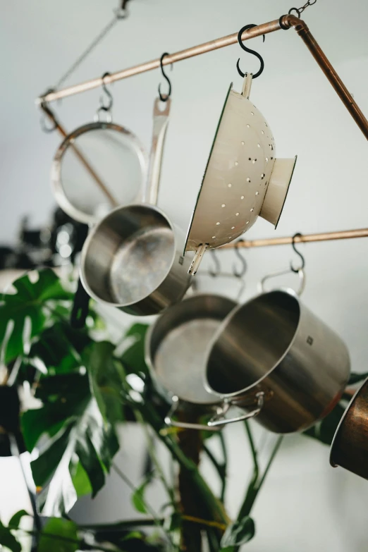 pots and pans hung from a metal bar