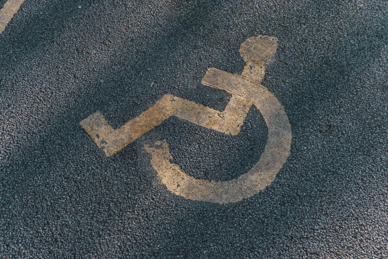 the handicap symbol on a pavement is written in metallic