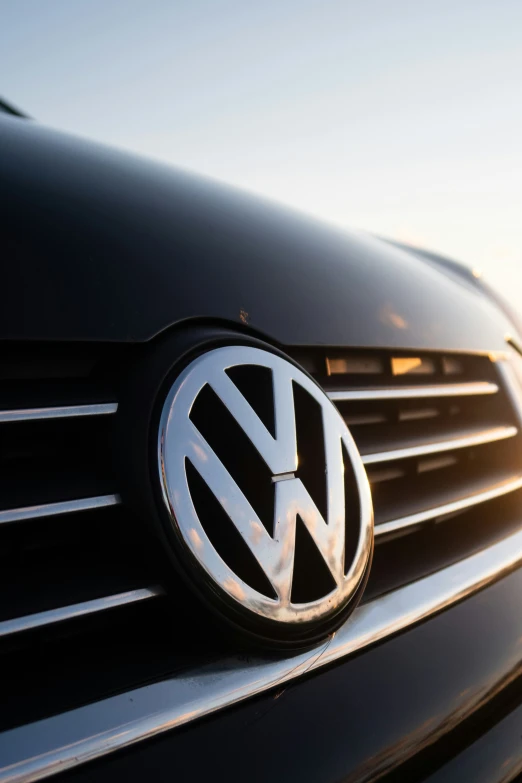 a volkswagen car emblem in front of a sky