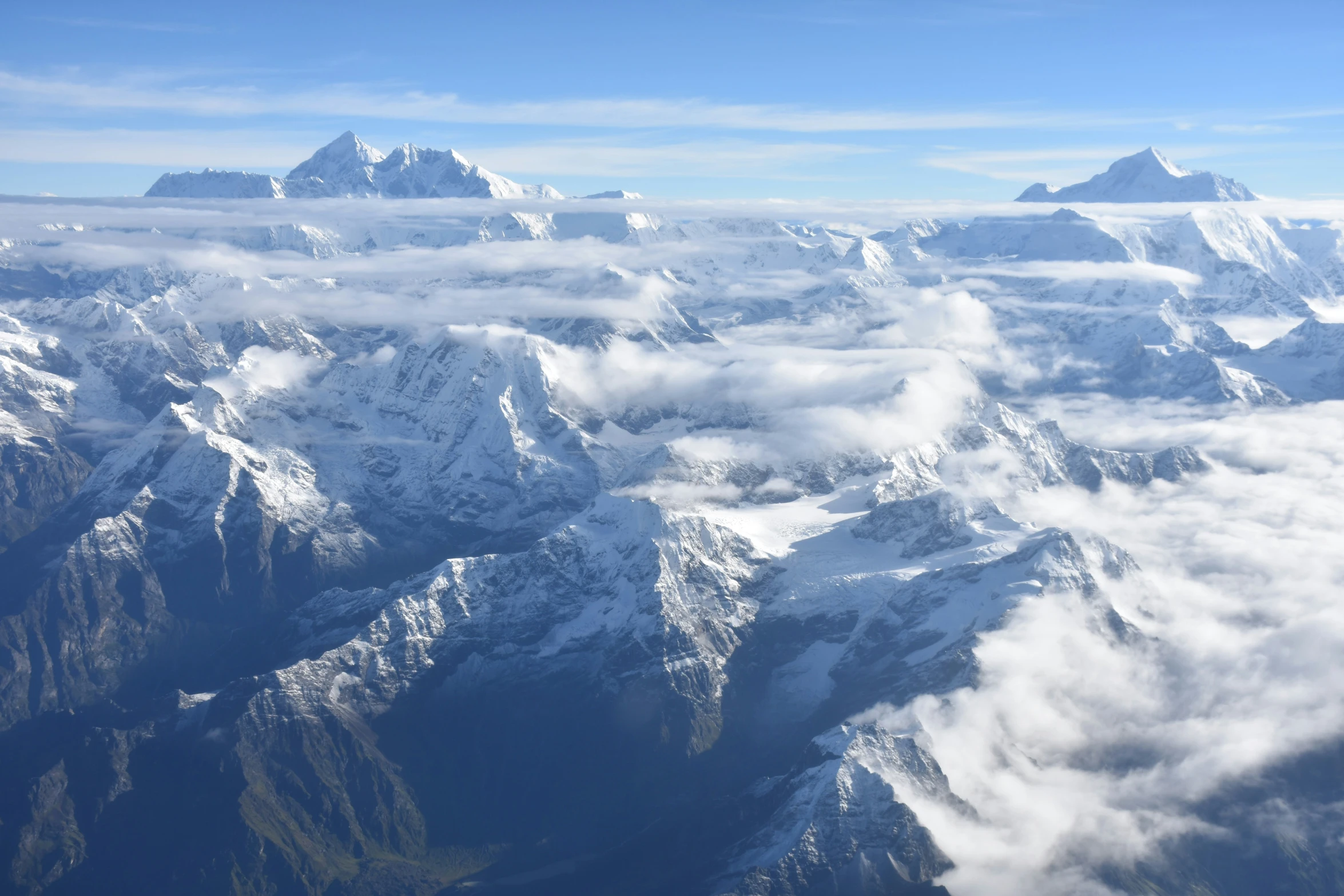 a view out an airplane window on some mountains