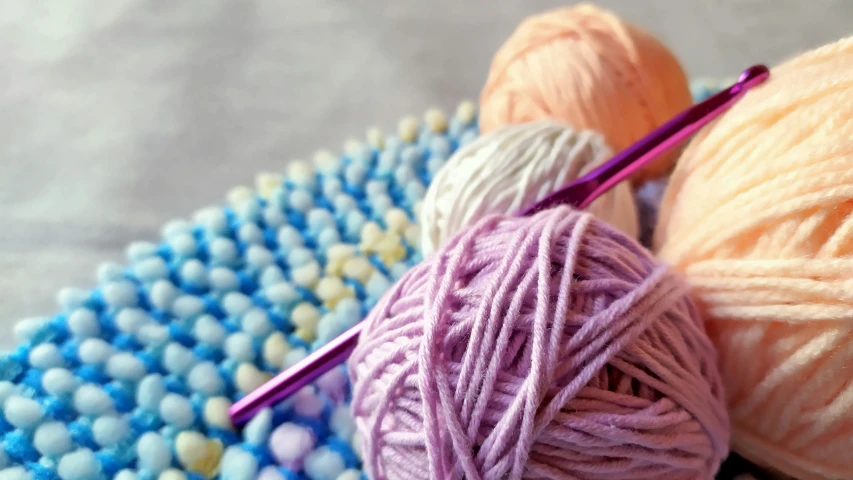 yarn and knitting needles are on a table