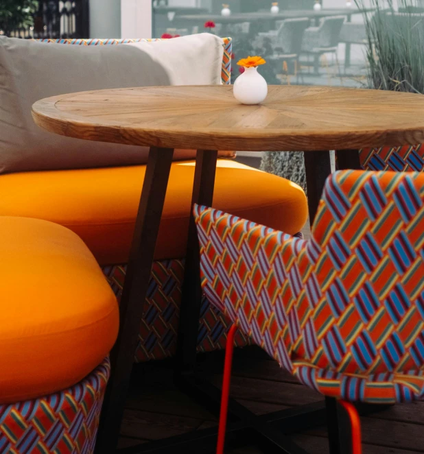 a table and some orange chairs on a deck